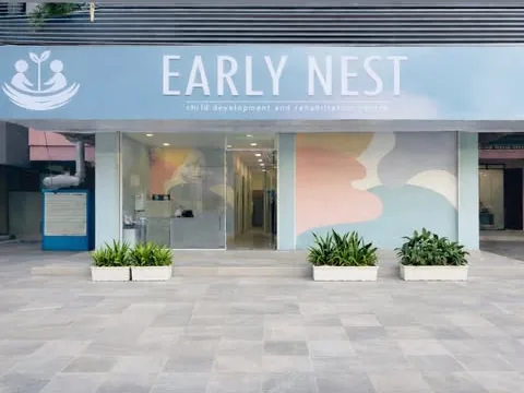 Early Nest's street front in Tirur, with its signage and a pastel mural beside the glass entrance